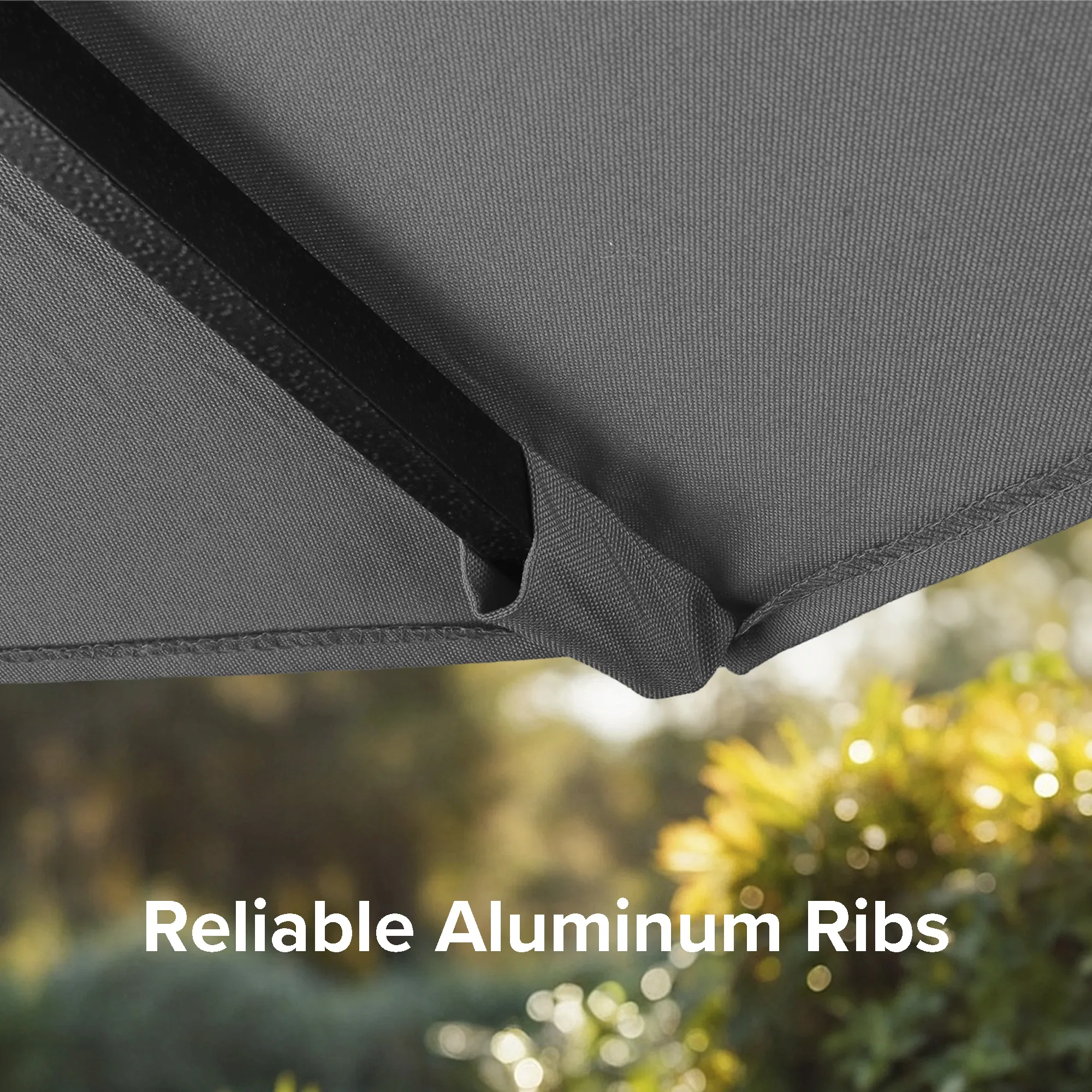 Close-up photo of the reliable aluminum ribs of the Golden State Series residential patio umbrella, illustrating their strength and flexibility, perfect for enduring various weather conditions at home.