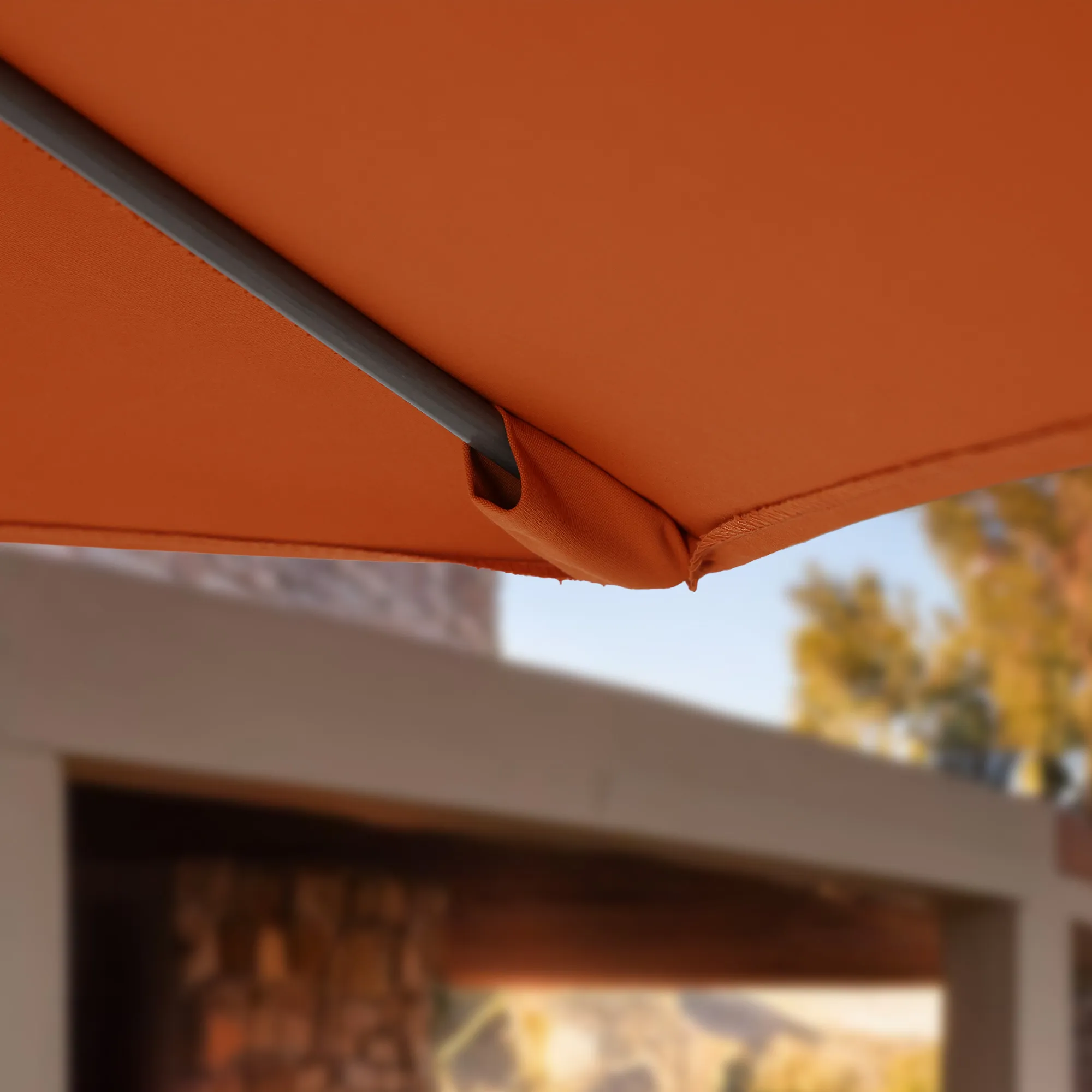 Close-up view of the flexible fiberglass ribs of the Sun Master Series Patio Umbrella by California Umbrella. These ribs are designed to provide superior wind resistance, bending slightly to absorb and disperse the force of strong breezes while maintaining the umbrella's shape and integrity. The image captures the ribs' robust construction and their integration with the umbrella's fabric, illustrating their role in enhancing durability and functionality in varying weather conditions.