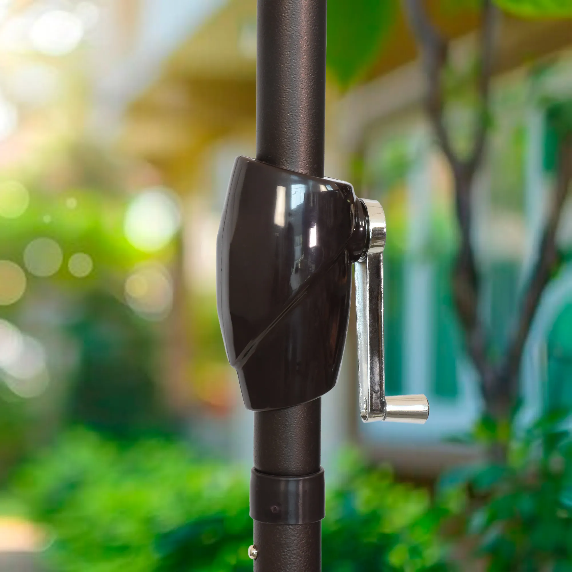 Detailed image of the easy crank lift mechanism on the Vento Series Patio Umbrella by California Umbrella. This user-friendly feature allows for quick and effortless opening and closing of the umbrella, enhancing the convenience of daily adjustments.